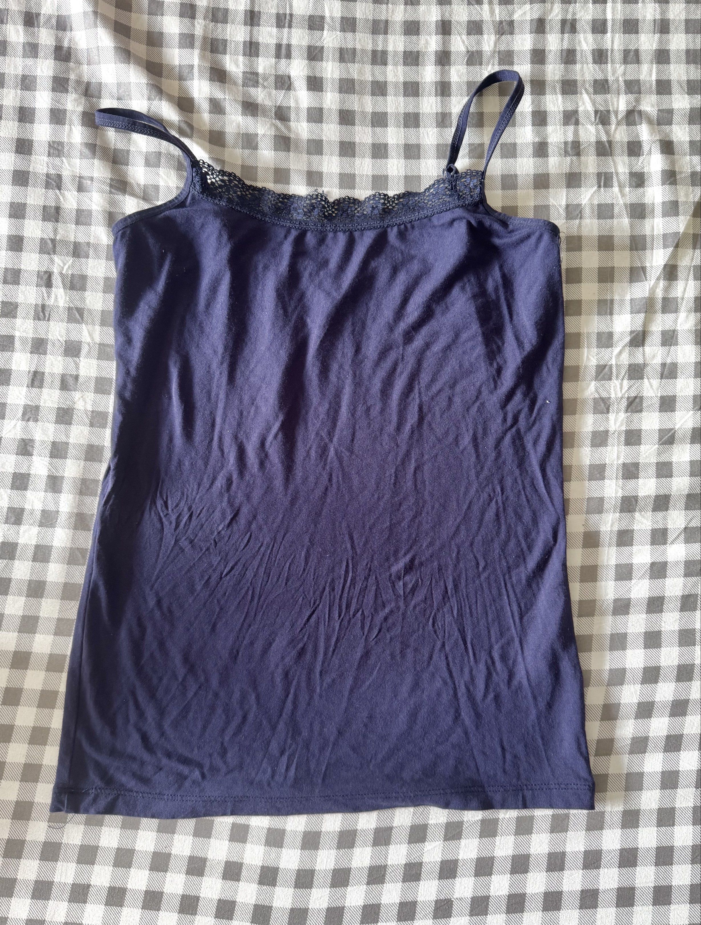 Navy Blue Lace Trim Tank Top (Category: Sleeveless) located in Manaoag. Submitted by park.chim (Listing ID 1421968956, Image 1). Description: - Navy blue tank top - Delicate lace trim on neckline - Thin spaghetti straps - Simple, fitted design - Made from soft, lightweight fabric - Ideal for warm weather - Versatile and easy to style.