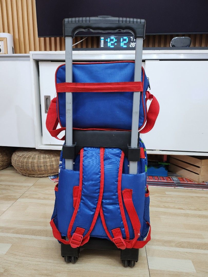 PJ Masks Rolling Backpack (Category: Strollers) located in Manila. Submitted by bajoyskie (Listing ID 1422058943, Image 2). Description: - PJ Masks rolling backpack - Blue and red color scheme - Features PJ Masks character graphics - Retractable handle and wheels for easy transport - Multiple compartments and pockets - Suitable for school or travel.