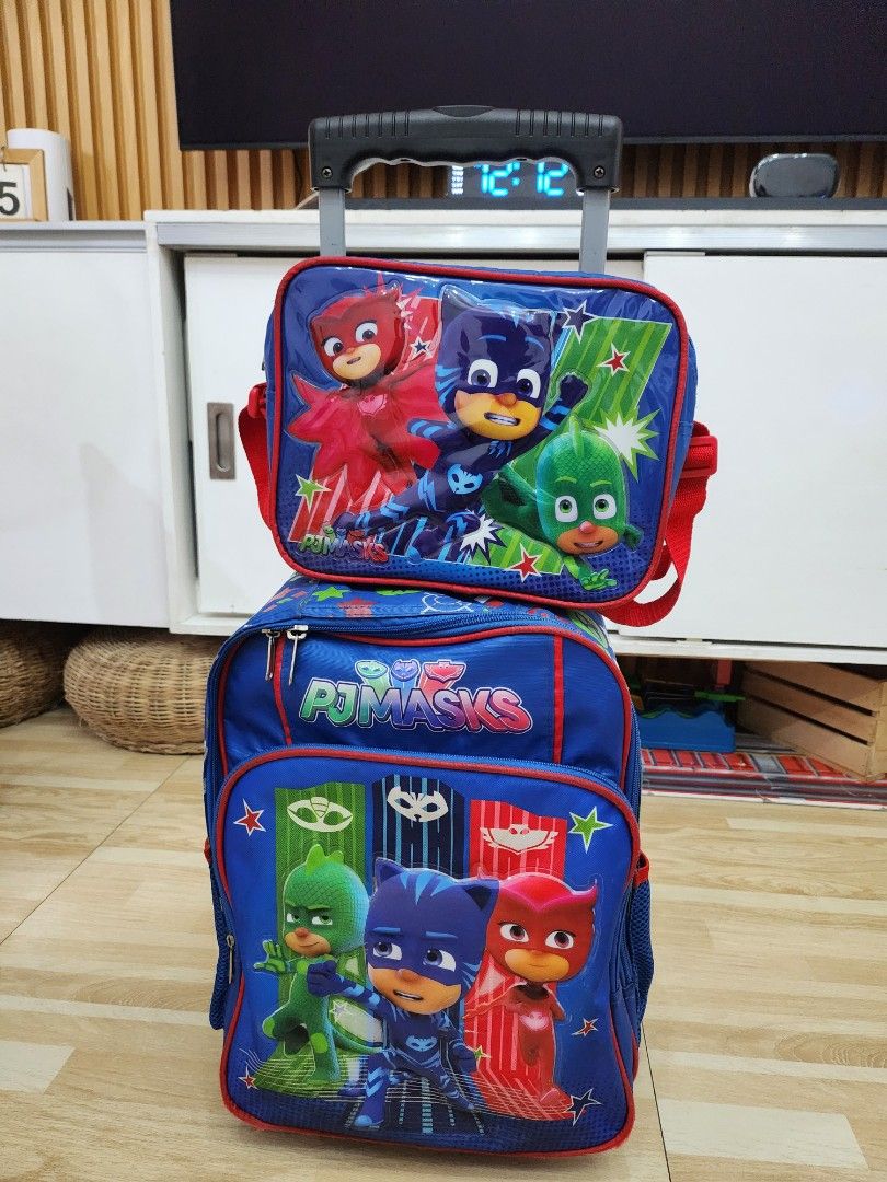 PJ Masks Rolling Backpack (Category: Strollers) located in Manila. Submitted by bajoyskie (Listing ID 1422058943, Image 1). Description: - PJ Masks rolling backpack - Blue and red color scheme - Features PJ Masks character graphics - Retractable handle and wheels for easy transport - Multiple compartments and pockets - Suitable for school or travel.