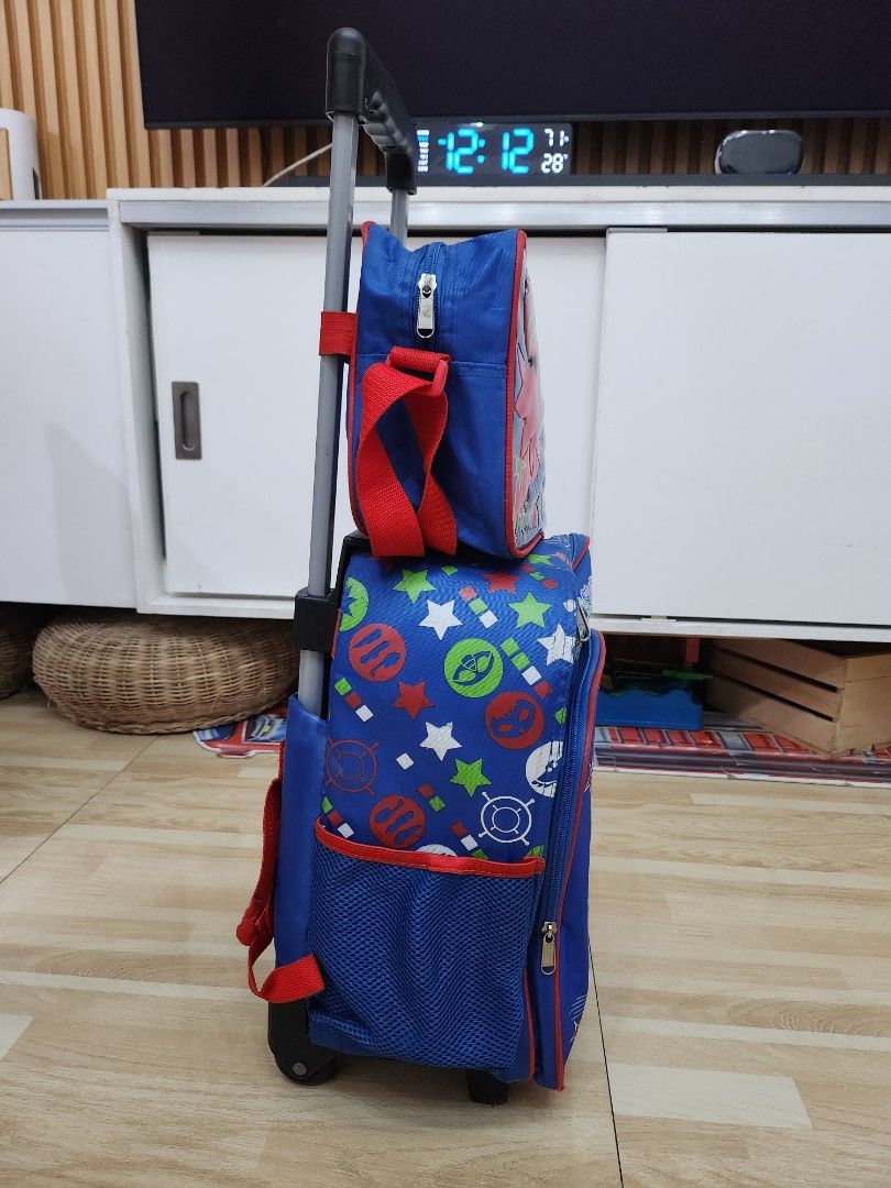 PJ Masks Rolling Backpack (Category: Strollers) located in Manila. Submitted by bajoyskie (Listing ID 1422058943, Image 3). Description: - PJ Masks rolling backpack - Blue and red color scheme - Features PJ Masks character graphics - Retractable handle and wheels for easy transport - Multiple compartments and pockets - Suitable for school or travel.