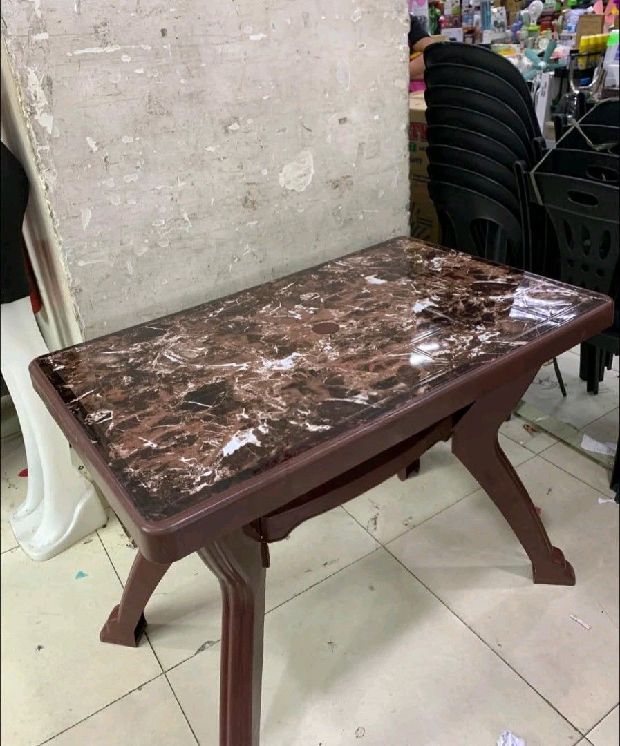 Plastic Table with Marble Design (Category: Tables & Sets) located in Manila. Submitted by asstditems (Listing ID 1421952643, Image 2). Description: - Durable plastic table - Stylish marble design - Rectangular tabletop - Sturdy legs - Includes a lower shelf for storage - Perfect for various uses 76.2x121.9x73.7cm. LXWXH .