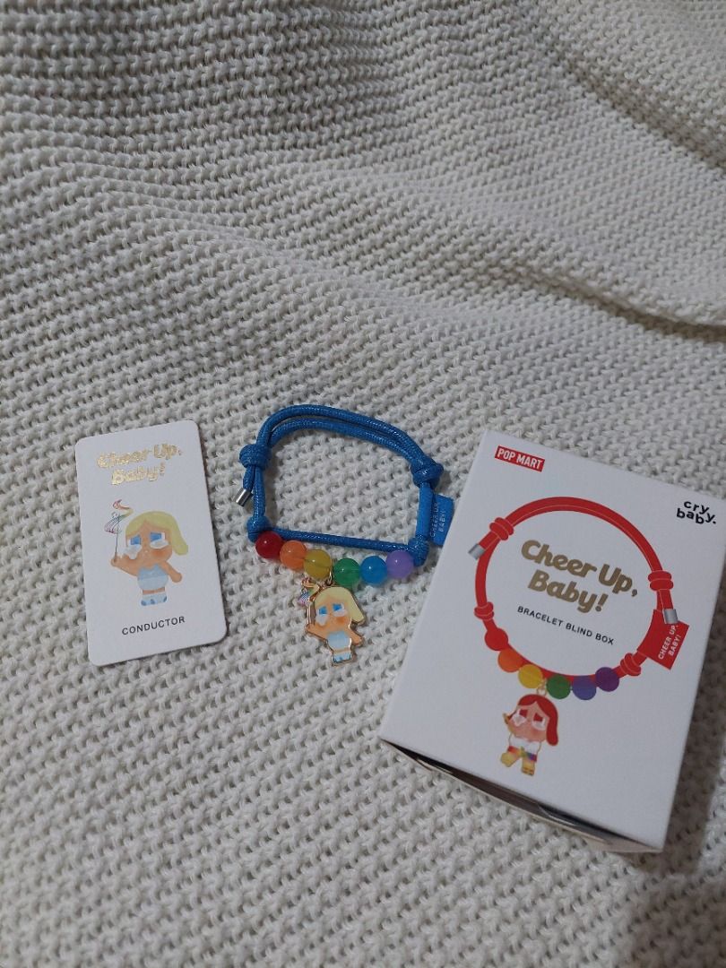 Pop Mart Cheer Up Baby Bracelet (Category: Bracelets) located in Las Pinas. Submitted by martinedee (Listing ID 1422070530, Image 3). Description: Pop Mart Cheer Up Baby bracelet. It features a blue cord with colorful beads and a charm. The bracelet comes with a matching card and the original box. The box has a red Pop Mart sticker. It is a blind box item..