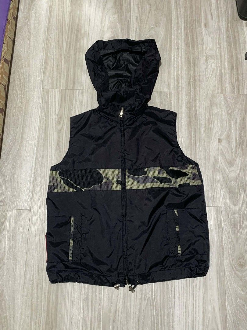 Prada Hooded Nylon Red Tab Camouflage Vest (Category: Vests) located in Naga. Submitted by unknwnstreetwear (Listing ID 1422077263, Image 3). Description: NO ISSUE AS NEW CONDITION WIDTH-20 INCHES LENGTH-23 INCHES.