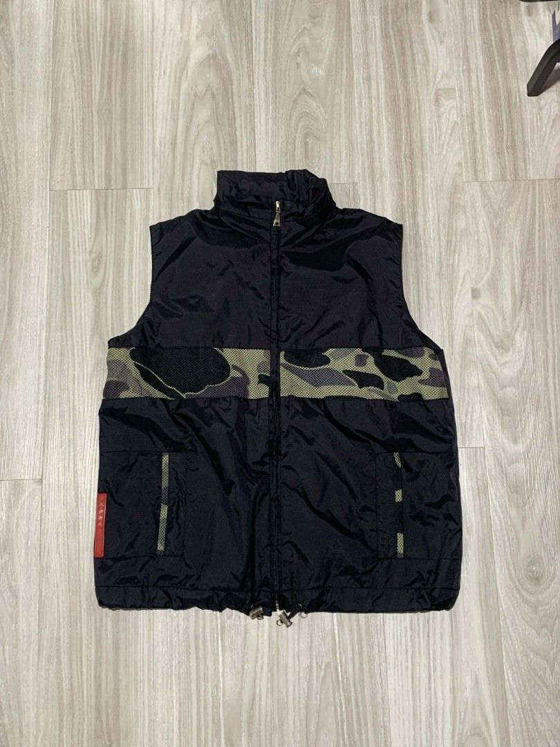 Prada Hooded Nylon Red Tab Camouflage Vest (Category: Vests) located in Naga. Submitted by unknwnstreetwear (Listing ID 1422077263, Image 1). Description: NO ISSUE AS NEW CONDITION WIDTH-20 INCHES LENGTH-23 INCHES.