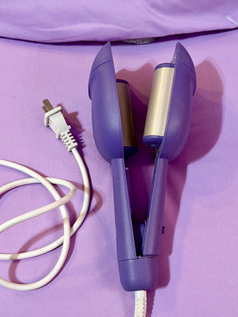 Purple Hair Waver (Category: Hair) located in Las Pinas. Submitted by mjm21 (Listing ID 1421945889, Image 1). Description: - Purple hair waver for creating wavy or mermaid hairstyles - Comfortable handle - Easy power button - Stylish paw print design - power cord.