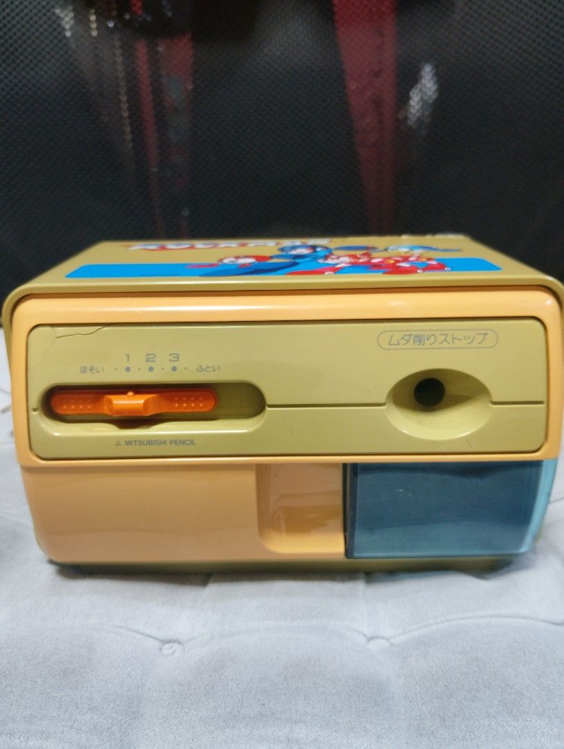 Rockman Mitsubishi Pencil Sharpener (Category: Vintage Collectibles) located in Manila. Submitted by boyhet.thrift15 (Listing ID 1422054748, Image 2). Description: - Vintage Rockman (Mega Man) pencil sharpener - Unique design featuring Rockman characters - Made by Mitsubishi Pencil - Includes power cord - Features a shavings drawer - Adjustable sharpness dial - not working /damage bandang gilid -selling 600.