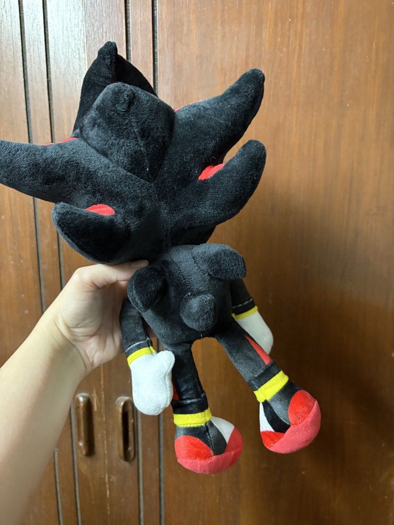 Shadow the Hedgehog Plush Toy (Category: Plushies & Soft Toys) located in San Juan City. Submitted by mksb0112 (Listing ID 1421988222, Image 3). Description: - Shadow the Hedgehog plush toy - Color scheme: Black, red, and white - Features a yellow muzzle and white gloves/shoes - Standing position - Includes star-shaped chest emblem - Soft and cuddly.
