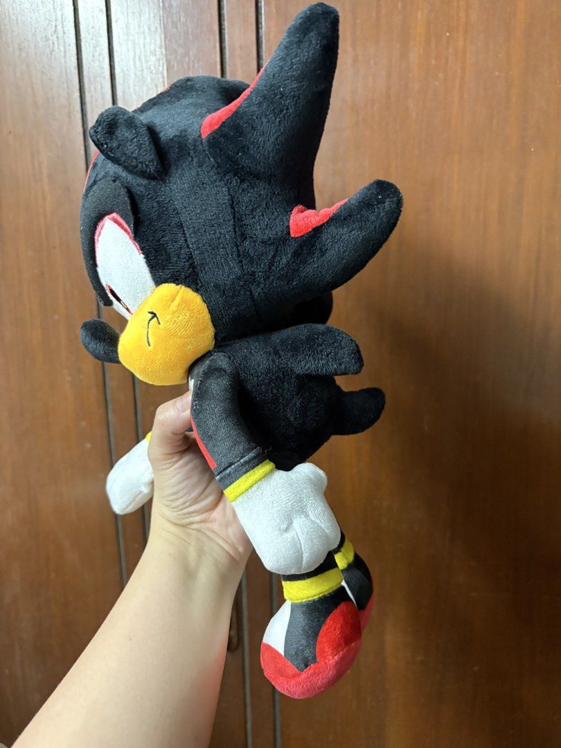 Shadow the Hedgehog Plush Toy (Category: Plushies & Soft Toys) located in San Juan City. Submitted by mksb0112 (Listing ID 1421988222, Image 2). Description: - Shadow the Hedgehog plush toy - Color scheme: Black, red, and white - Features a yellow muzzle and white gloves/shoes - Standing position - Includes star-shaped chest emblem - Soft and cuddly.