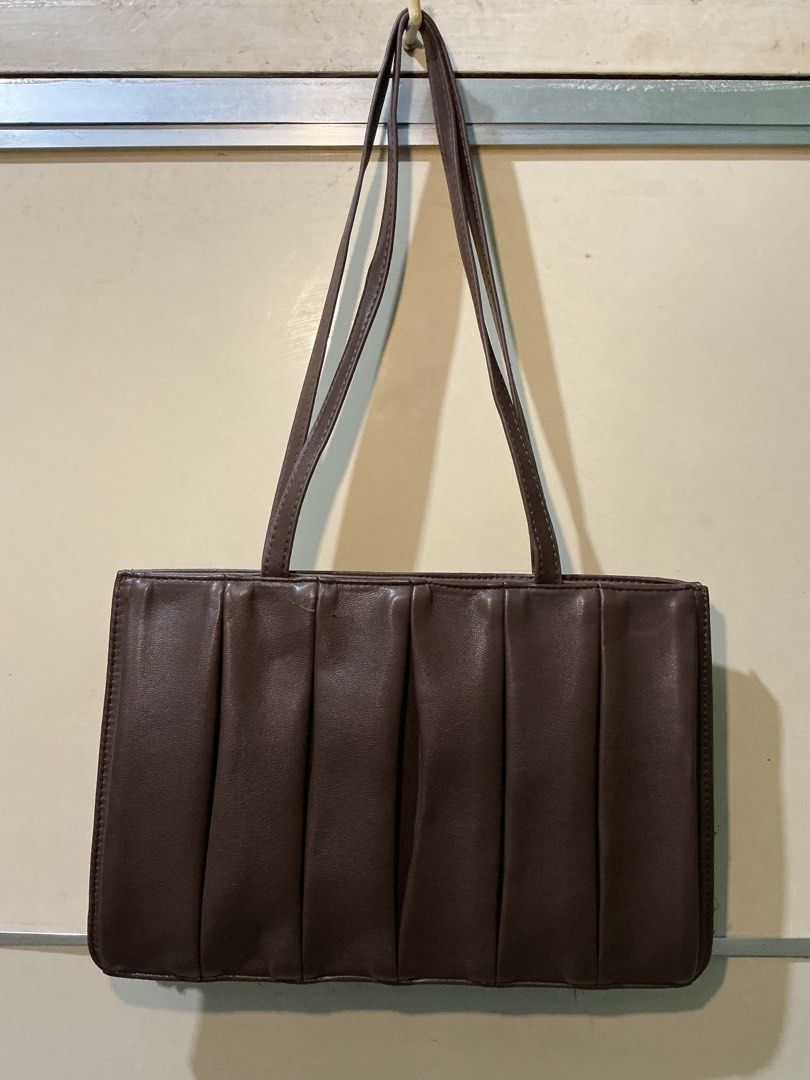Shecarry Brown Pleated Shoulder Bag (Category: Shoulder Bags) located in Cavite. Submitted by audepages (Listing ID 1421956029, Image 2). Description: - Stylish brown shoulder bag - Pleated front design - Rectangular shape - Long straps - Interior pocket - Magnetic closure - Minor wear on exterior - Perfect for everyday use -Can fit 11-inch ipad MOP: Gcash MOD: J&T Lalamove if nearby Location: Imus, Cavite .