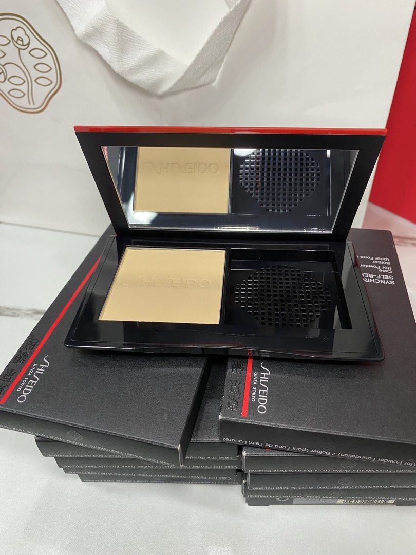 Shiseido Synchro Self-Refreshing Powder Foundation (Category: Makeup) located in Manila. Submitted by kirtsiecel51729 (Listing ID 1421966281, Image 2). Description: - Shiseido Synchro Self-Refreshing Powder Foundation - Includes powder foundation and mirror - Brand new, in original packaging - Features the Shiseido logo and product information on the box - Light shade - Compact has a black base with a red accent.
