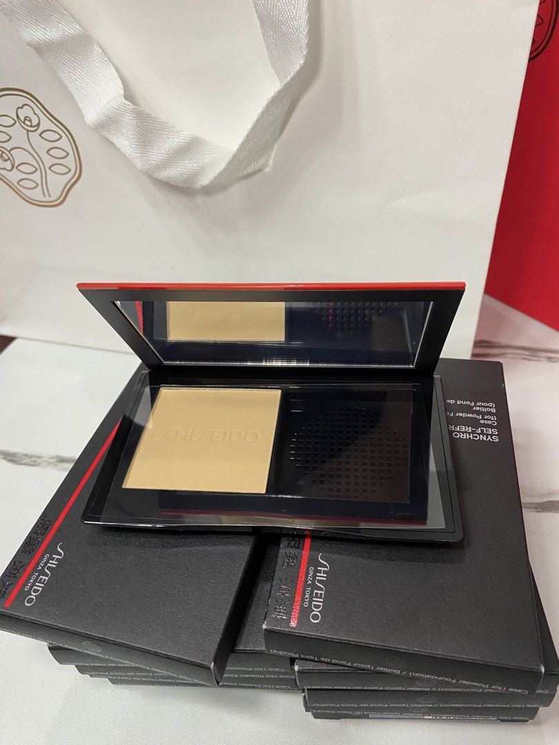 Shiseido Synchro Self-Refreshing Powder Foundation (Category: Makeup) located in Manila. Submitted by kirtsiecel51729 (Listing ID 1421966281, Image 1). Description: - Shiseido Synchro Self-Refreshing Powder Foundation - Includes powder foundation and mirror - Brand new, in original packaging - Features the Shiseido logo and product information on the box - Light shade - Compact has a black base with a red accent.