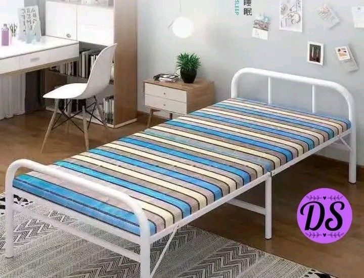 Single Bed Frame with Mattress (Category: Bed Frames & Mattresses) located in Manila. Submitted by micoooy (Listing ID 1421944442, Image 1). Description: - New single bed frame - Foldable white metal frame - Includes striped mattress (blue, yellow, gray) - Item is brand new - Still in original packaging.