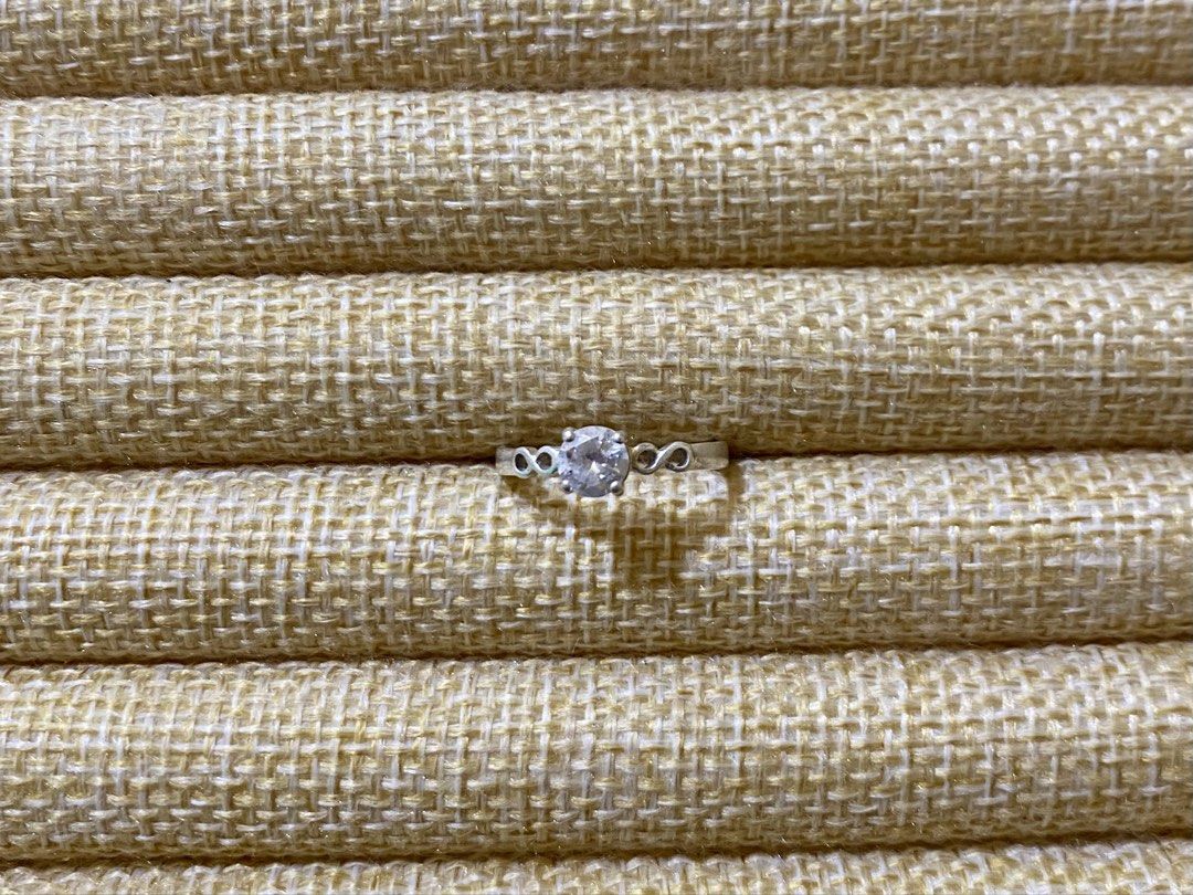 Solitaire Infinity engagement or promise ring | S925 (Category: Rings) located in Solano. Submitted by silvershineph (Listing ID 1421951773, Image 1). Description: ✧ Product / Item Name: Solitaire Infinity engagement or promise ring ✧ Description: A solitaire setting featuring a single large, round-cut center stone. The band is accented with delicate infinity symbols flanking the center stone, symbolizing eternal love and commitment. ✧ Size: 6.5 