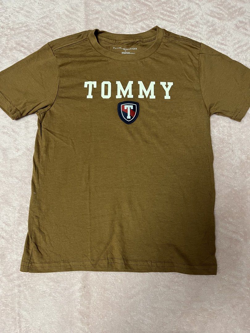 Tommy Hilfiger Brown T-shirt (Category: Babies & Kids Fashion) located in Paranaque City. Submitted by princessann0721 (Listing ID 1422056450, Image 1). Description: - Tommy Hilfiger T-shirt - Brown color - Classic Tommy Hilfiger logo on the front - Short sleeves - Crew neck - Soft and comfortable fabric - Ideal for everyday wear - Brand New but no Tag.