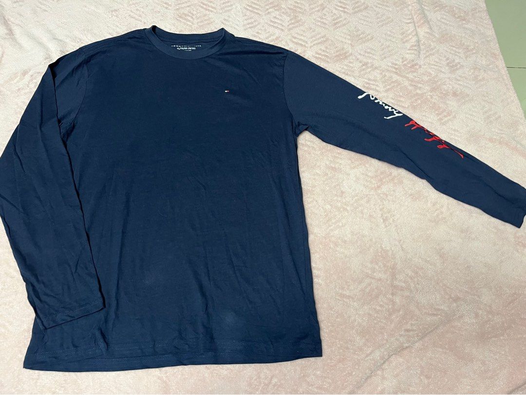 Tommy Hilfiger Long Sleeve Shirt (Category: Tshirts & Polo Shirts ) located in Paranaque City. Submitted by princessann0721 (Listing ID 1422058497, Image 1). Description: - Navy blue Tommy Hilfiger long sleeve shirt - Features Tommy Hilfiger logo on chest - Brand name printed on left sleeve - Crew neck design - Regular fit - Ideal for casual wear - Brand New but no Tag - will fit small or medium adult - size 18-20 kids on label.