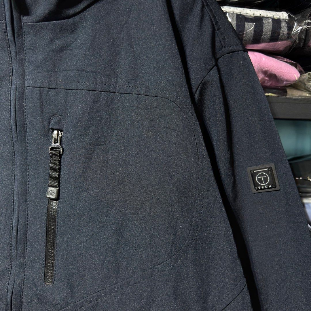TUMI Tech - Softshell Jacket Packable Hood (Category: Coats, Jackets and Outerwear) located in Cavite. Submitted by gooditems.cavite (Listing ID 1421950809, Image 3). Description: - Tumi Tech Jacket - Size: XXL 27x29 can fit xl - Color: Dark Navy - Features: Full zip closure, multiple zippered pockets, high collar, hidden hood - Lining: Quilted for warmth - Made in Vietnam.