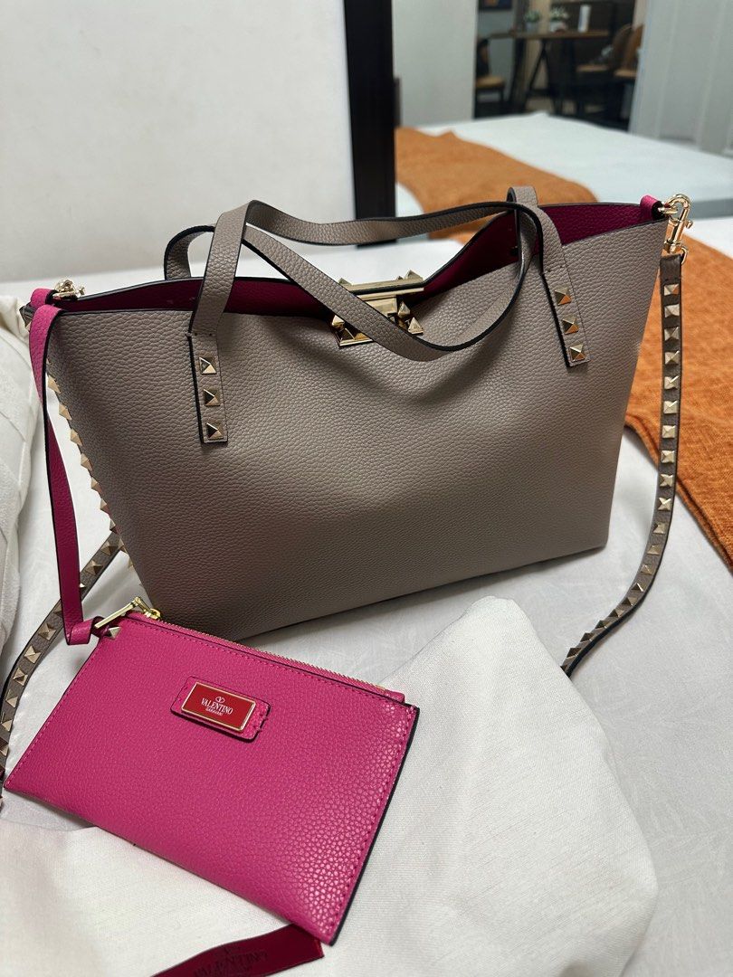 Valentino Rockstud Tote Bag (Category: Luxury Bags & Wallets) located in Quezon City. Submitted by luxpro.mnl (Listing ID 1422003811, Image 3). Description: - Valentino Rockstud Tote Bag - Grey exterior, pink interior - Includes detachable shoulder strap - Matching pink wallet included - Gold-tone hardware - Studded details - Medium size, perfect for everyday use - Comes with dust bag.