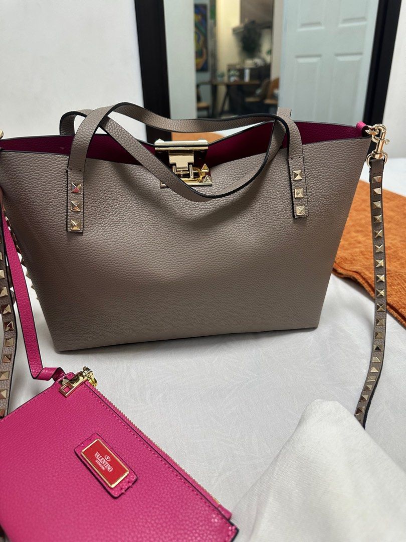 Valentino Rockstud Tote Bag (Category: Luxury Bags & Wallets) located in Quezon City. Submitted by luxpro.mnl (Listing ID 1422003811, Image 1). Description: - Valentino Rockstud Tote Bag - Grey exterior, pink interior - Includes detachable shoulder strap - Matching pink wallet included - Gold-tone hardware - Studded details - Medium size, perfect for everyday use - Comes with dust bag.