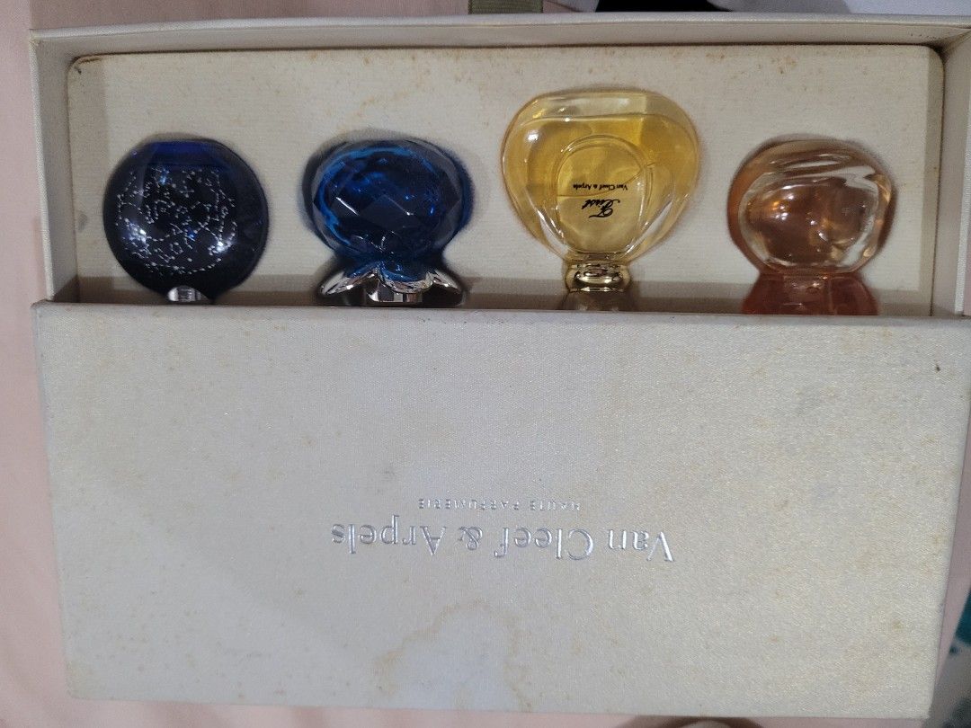 Van Cleef & Arpels Miniature Perfume Set (Category: Fragrance & Deodorants) located in Manila. Submitted by flzoneeee (Listing ID 1421987821, Image 1). Description: - Van Cleef & Arpels Miniature Perfume Set - Includes four miniature perfumes - Variety of fragrances - Bottles in amber, yellow, blue, and dark blue with glitter - Presented in a cream-colored box - Perfect for gifting or trying different scents.