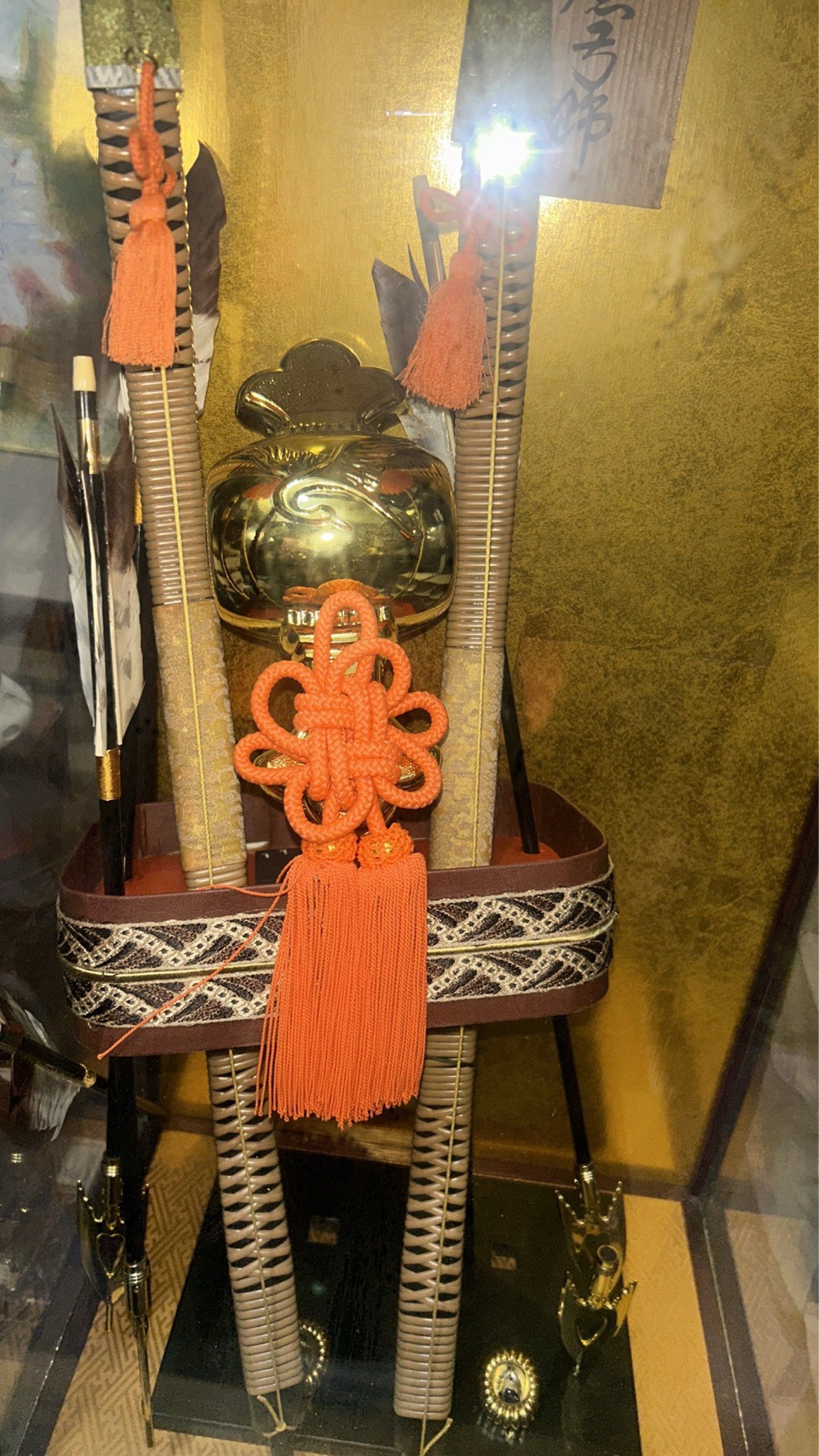 VINTAGE JAPANESE SAMURAI GLASS DECOR DISPLAY (Category: Vintage Collectibles) located in Valenzuela. Submitted by a0457802ad693804a023bab9eae5b7 (Listing ID 1421976599, Image 3). Description: Approx H28”/ L15” inch - Vintage Japanese samurai display - Glass case with wooden frame and black base - Features a golden helmet and arrows - Decorative elements and gold background - Includes an orange tassel - Intricate details Sure buyer may inquire vid