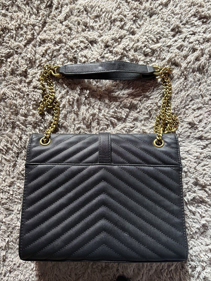 YSL Black Shoulder Bag with Gold Chain (Category: Luxury Bags & Wallets) located in Manila. Submitted by epicdragon403 (Listing ID 1421977507, Image 2). Description: Details: • Color: Black with gold hardware • Chain strap with leather shoulder pad • Chevron quilted design (front & back) • Flap closure • Spacious interior Condition: • Preloved – with visible signs of use • Interior red lining has peeling/cracking (see photos) • Some scratches and