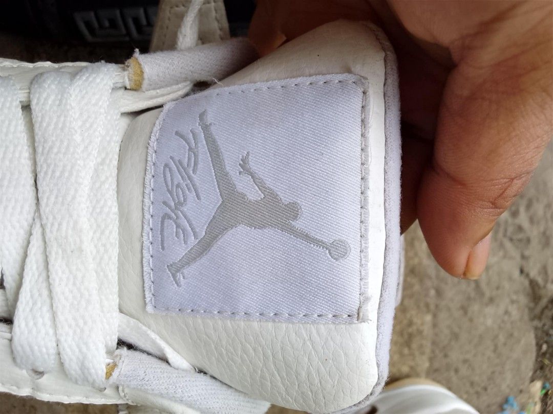 Air Jordan 4 White (Category: Sneakers) located in Calabanga. Submitted by foxsthrift_420 (Listing ID 1422106095, Image 3). Description: - Air Jordan 4 - Color: White - Size: US 8.5Y, UK 7.5,EUR 42 - Features Jumpman logo - Signs of wear on soles and uppers - White laces and inner lining - Mesh detail on the side.
