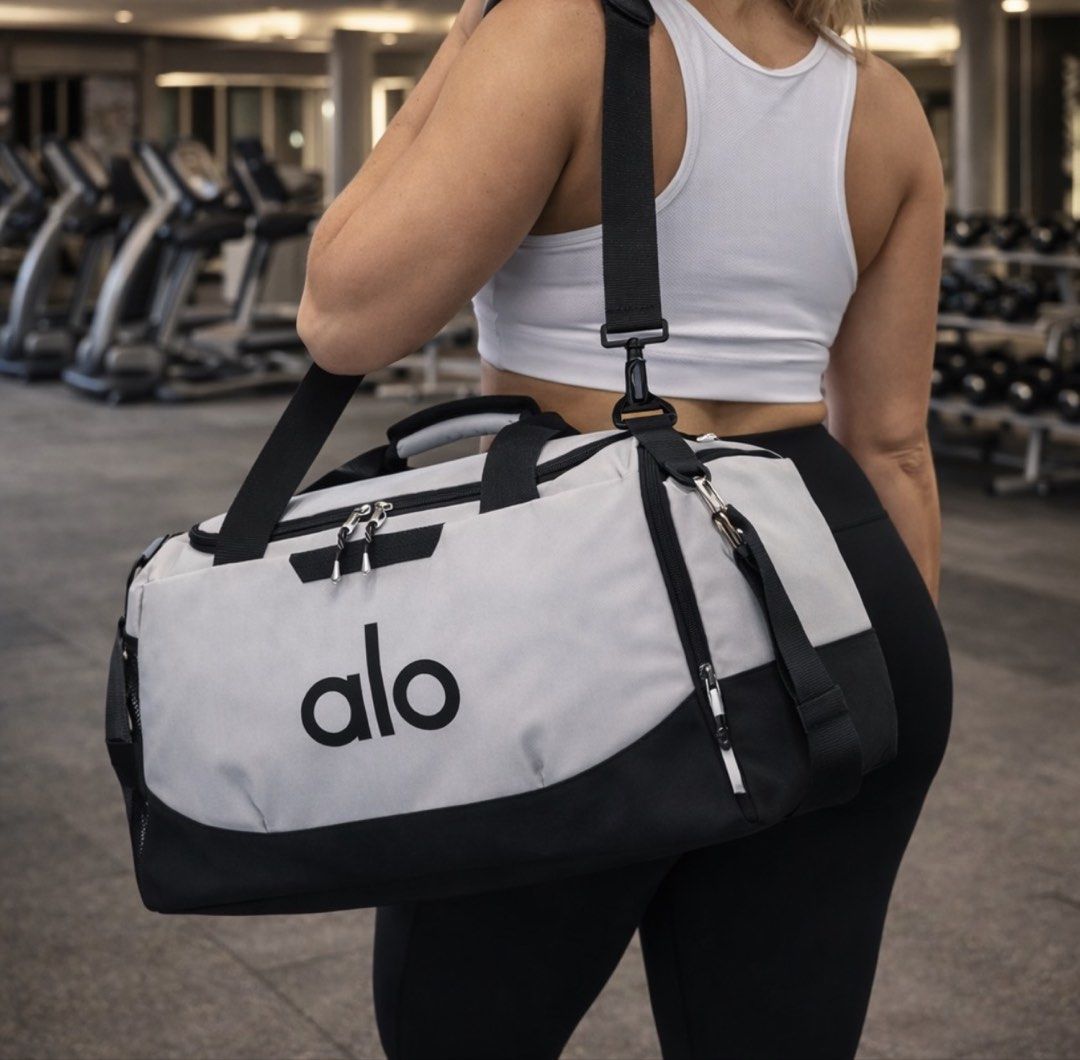 Alo Duffle Bag (Category: Cross-body Bags) located in Manila. Submitted by mabssy-2000 (Listing ID 1422147042, Image 2). Description: - Stylish Alo duffle bag - Ideal for gym or travel - Spacious main compartment - Includes a shoulder strap - Available in multiple colors - Made of durable material - Features the Alo logo.