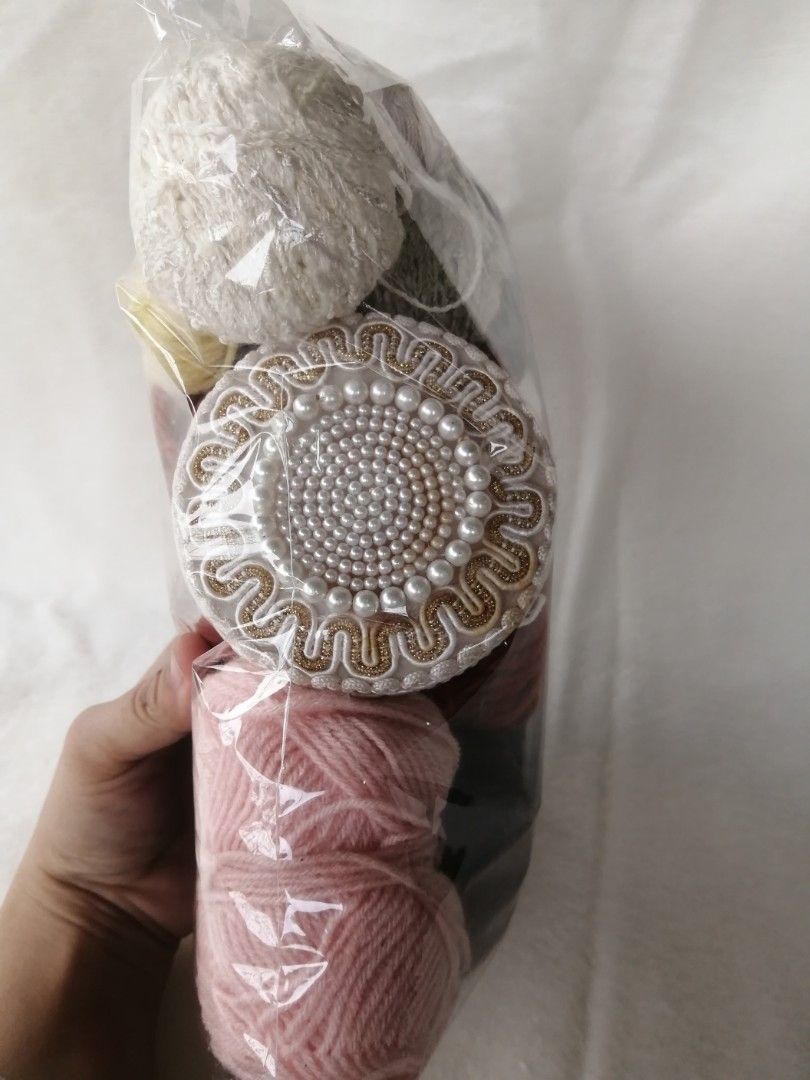 Assorted Yarn Bundle Japan (Category: Craft Supplies & Tools) located in Liloan. Submitted by aidolcapz88 (Listing ID 1422108861, Image 3). Description: - Yarn bundle for crafting. - Colors: Brown, pink, black, and yellow. - Includes a decorative item with a pearl design. - Packaged in a clear plastic bag..