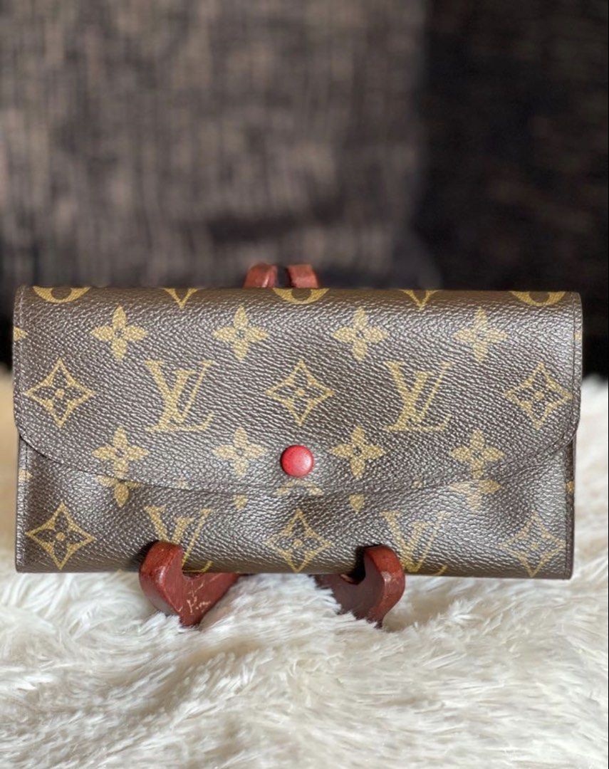 Authentic LV Emelie Monogram Wallet (Category: Luxury Bags & Wallets) located in Muntinlupa City. Submitted by cher_ami (Listing ID 1422209702, Image 1). Description: - Authentic Louis Vuitton Emelie Wallet - Classic monogram pattern - Magenta interior - Multiple card and cash compartments - Zippered pocket - Snap closure - Interior has initials stamped at an LV Store - With date code - No inclusions. Wallet only.
