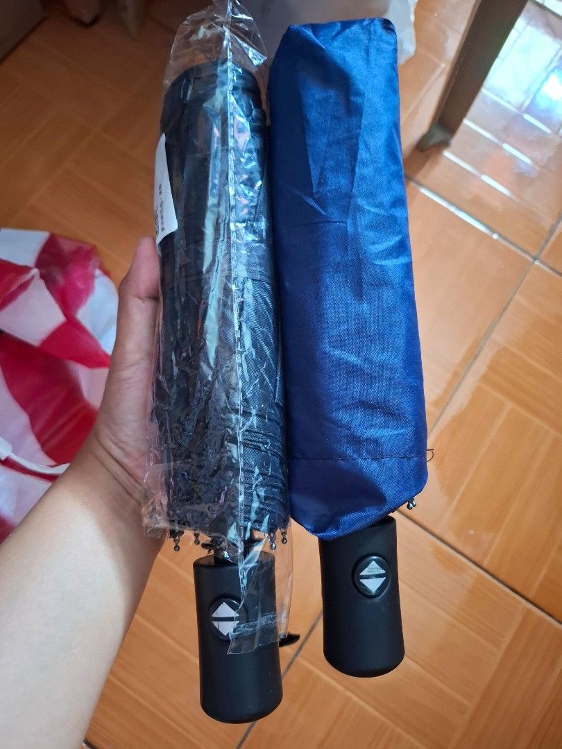 Automatic Foldable Umbrella - sold each (Category: Umbrellas) located in Quezon City. Submitted by an.marie (Listing ID 1421976200, Image 2). Description: Compact foldable umbrella. Easy to carry, with a black handle, button, and wrist strap. Comes in clear plastic packaging..