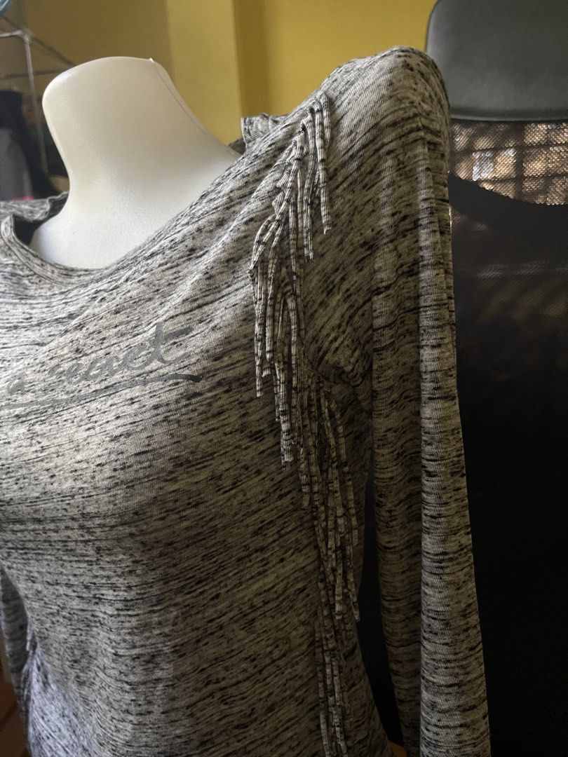 Bershka Fringe Top - Size S (Category: Sleeveless) located in Santa Cruz. Submitted by lilpurpleseven (Listing ID 1422232189, Image 2). Description: Bershka top with fringe detailing. Features a round neckline and long sleeves. The top is gray with a speckled pattern and the words "tell me a secret" printed on the front. Made in Turkey. Size S..