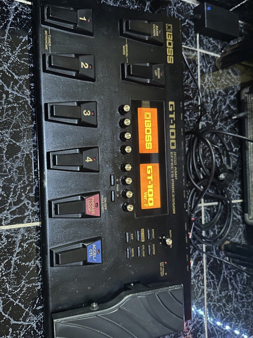 Boss GT-100 Multi-Effects Processor (Category: Musical Instruments) located in Las Pinas. Submitted by maussygoods (Listing ID 1422121754, Image 2). Description: Boss GT-100 is a multi-effects processor for guitar. It features numerous effects, amp modeling, and a phrase looper. It has multiple footswitches for easy control and a built-in expression pedal. The display shows patch names and settings. It has various input and output jacks for conne