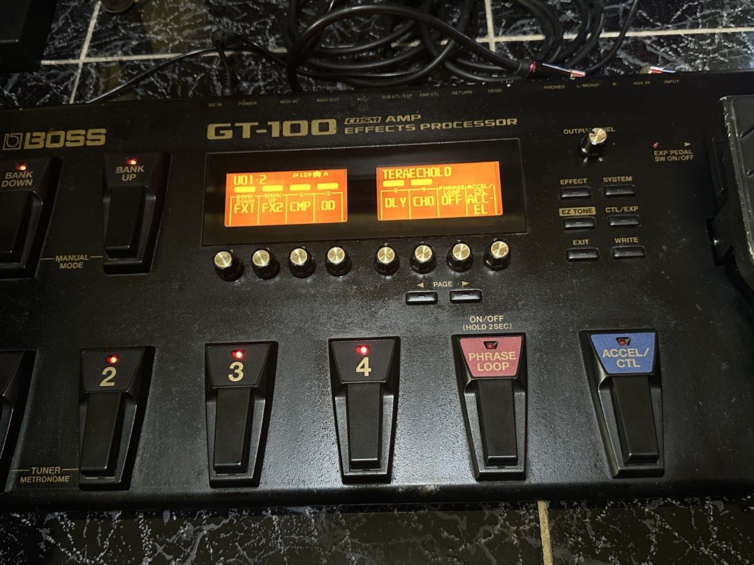 Boss GT-100 Multi-Effects Processor (Category: Musical Instruments) located in Las Pinas. Submitted by maussygoods (Listing ID 1422121754, Image 3). Description: Boss GT-100 is a multi-effects processor for guitar. It features numerous effects, amp modeling, and a phrase looper. It has multiple footswitches for easy control and a built-in expression pedal. The display shows patch names and settings. It has various input and output jacks for conne