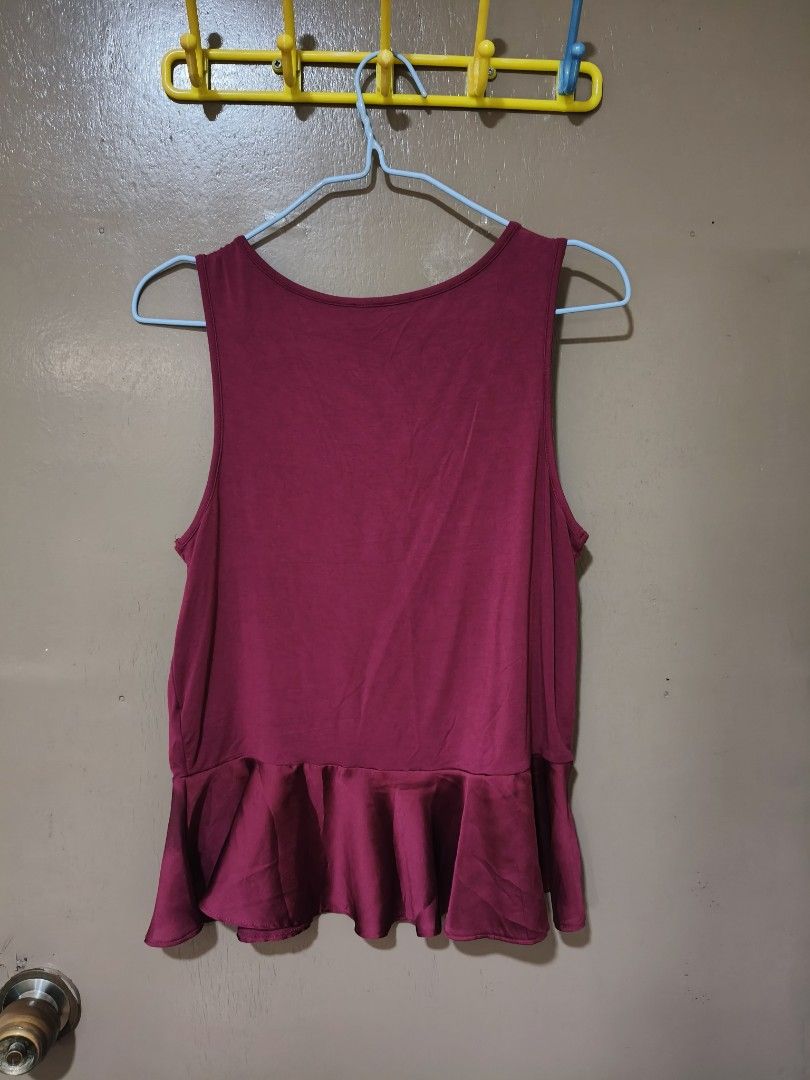 Burgundy Sleeveless Top with Ruffle Hem (Category: Sleeveless) located in Quezon City. Submitted by miss.len (Listing ID 1422197812, Image 2). Description: Sleeveless top features a flattering ruffle hem. The top is a rich burgundy color. It has a round neckline and a simple, elegant design. Perfect for pairing with skirts or pants for a chic look..