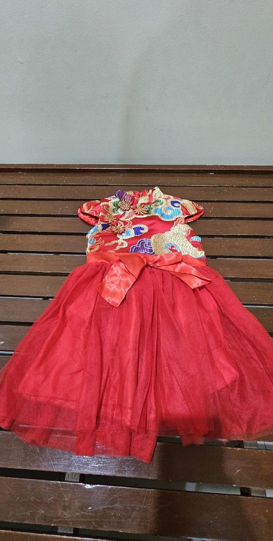 Chinese Traditional Dress (Category: Babies & Kids Fashion) located in Cebu City. Submitted by everythingonearth (Listing ID 1422167365, Image 1). Description: - Exquisite red Chinese traditional dress - Intricate gold dragon and floral embroidery - Includes a red bow at the waist - Features a layered tulle skirt - Short sleeves and decorative buttons - Ideal for special occasions.