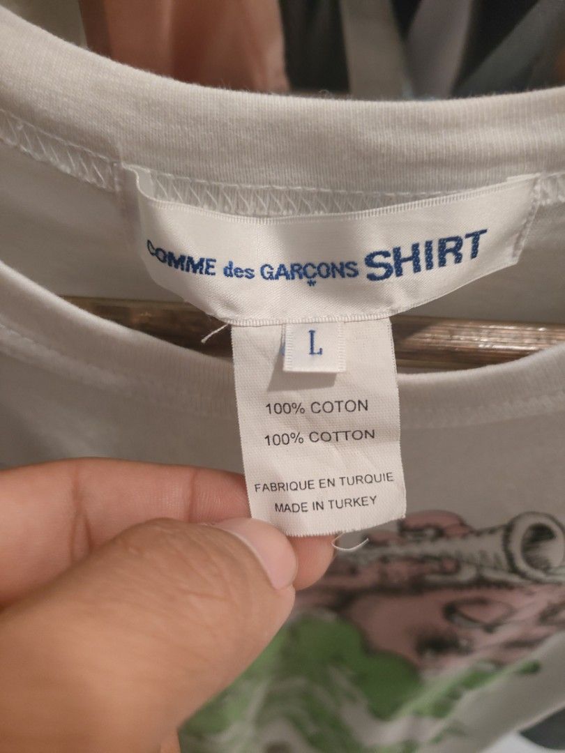 Comme des Garcons Shirt Kaws Graphic Tee (Category: Tshirts & Polo Shirts ) located in Quezon City. Submitted by markythegrappler17 (Listing ID 1422156896, Image 3). Description: - White Comme des Garcons Shirt - Features a Kaws graphic print - Size: L - Material: 100% Cotton - Made in Turkey - Crew neck - Short sleeves - Care instructions: Machine wash cold, do not bleach, cool iron.