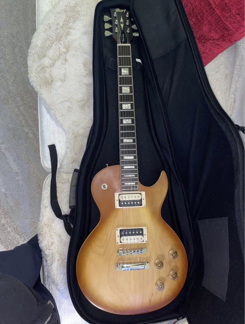 Cort CR300 Classic Rock Electric Guitar (Category: Musical Instruments) located in Manila. Submitted by wavy.scentss (Listing ID 1422200639, Image 1). Description: Very Good Condition Personal Owned I dont really use this Looks Brand new just needs a little cleaning - Cort CR300 electric guitar - Sunburst finish - Includes gig bag and hex key - Set-neck construction - Dual humbucker pickups - Tune-O-Matic bridge - Rosewood fretboard with rectangu