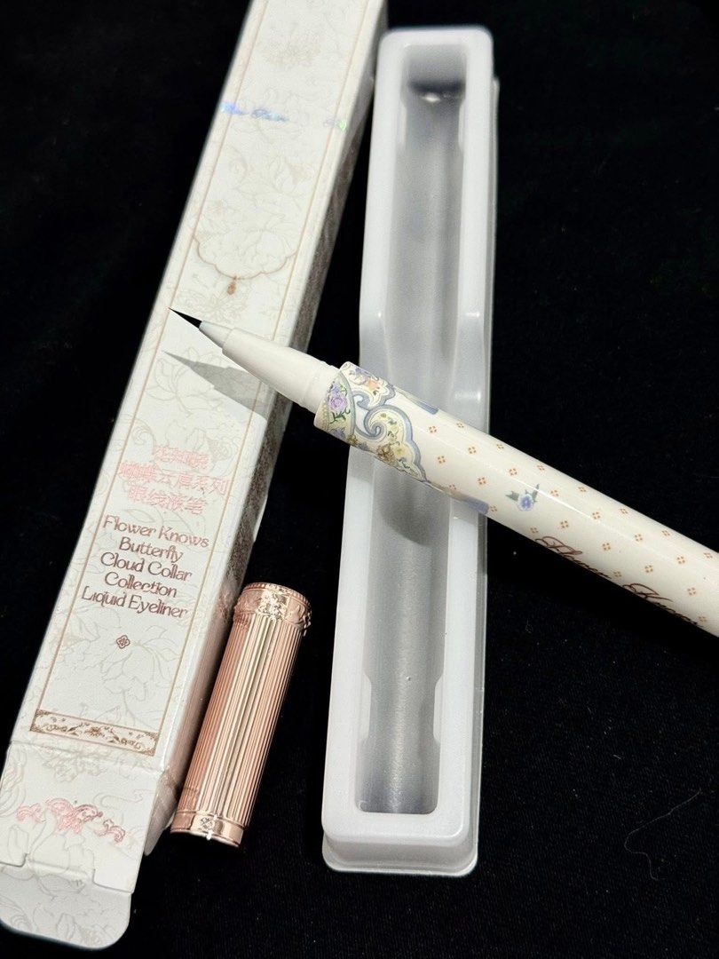 Flower Knows Butterfly Cloud Collar Liquid Eyeliner (Category: Makeup) located in Manila. Submitted by n4thlie (Listing ID 1422173954, Image 1). Description: - Brand new Flower Knows Butterfly Cloud Collar Liquid Eyeliner. - Elegant white pen design with floral and butterfly motifs. - Rose gold cap. - Comes in a matching box with brand and product details. - Never been used..