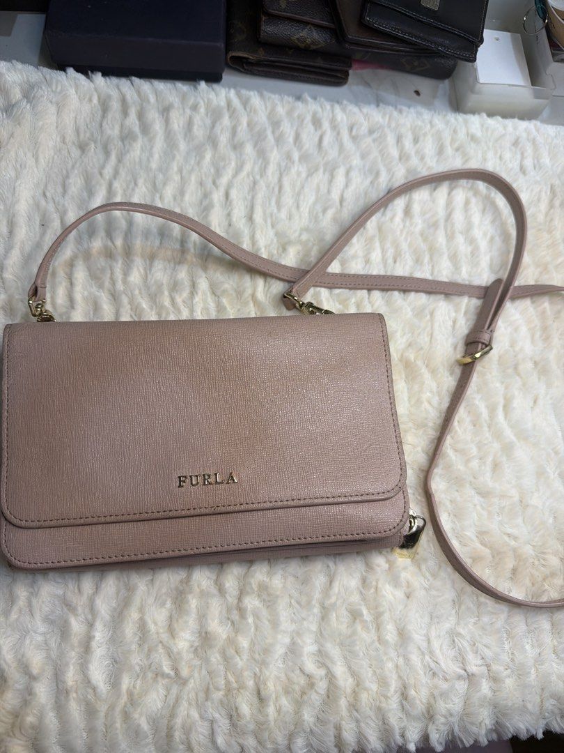 Furla Crossbody Wallet Bag (Category: Luxury Bags & Wallets) located in Antipolo. Submitted by ambercs (Listing ID 1422094940, Image 1). Description: - Authentic Furla crossbody bag - Blush pink color - Long adjustable strap - Secure zip-around closure - Interior with multiple compartments and card slots - Genuine leather material - Furla logo on front and inside - authentic - preloved - cute and rare type - 2 pouch/ wallet in 1 - can fit iphone 