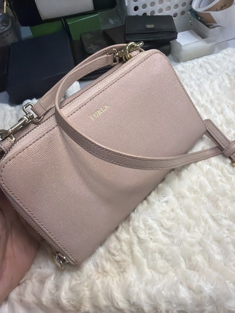 Furla Crossbody Wallet Bag (Category: Luxury Bags & Wallets) located in Antipolo. Submitted by ambercs (Listing ID 1422094940, Image 2). Description: - Authentic Furla crossbody bag - Blush pink color - Long adjustable strap - Secure zip-around closure - Interior with multiple compartments and card slots - Genuine leather material - Furla logo on front and inside - authentic - preloved - cute and rare type - 2 pouch/ wallet in 1 - can fit iphone 