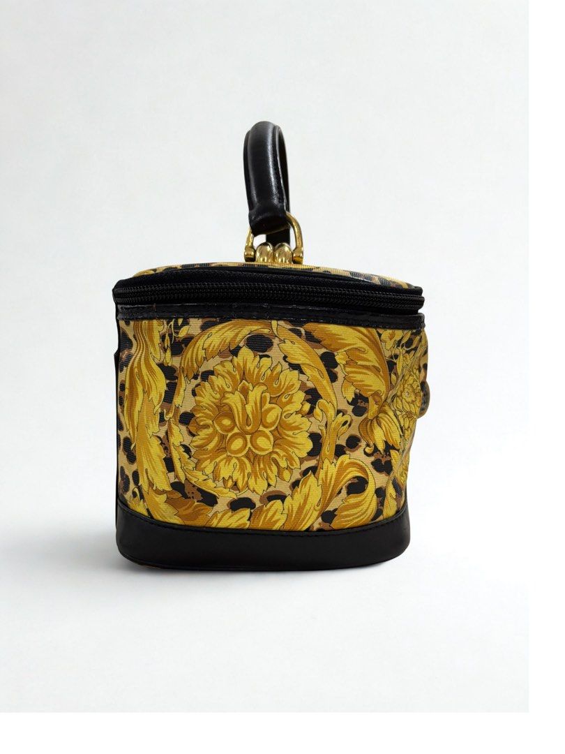 Gianni Versace Vanity Bag (Category: Luxury Bags & Wallets) located in Paranaque City. Submitted by katlouieleandicho (Listing ID 1422144166, Image 3). Description: - Vintage Gianni Versace vanity bag - Gold and black baroque print - Black leather handle and base - Gold fabric interior lining - Small zippered pocket with Gianni Versace label - Top zipper closure - Decorative charms.