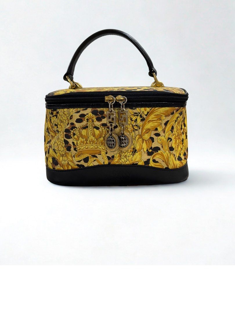 Gianni Versace Vanity Bag (Category: Luxury Bags & Wallets) located in Paranaque City. Submitted by katlouieleandicho (Listing ID 1422144166, Image 1). Description: - Vintage Gianni Versace vanity bag - Gold and black baroque print - Black leather handle and base - Gold fabric interior lining - Small zippered pocket with Gianni Versace label - Top zipper closure - Decorative charms.