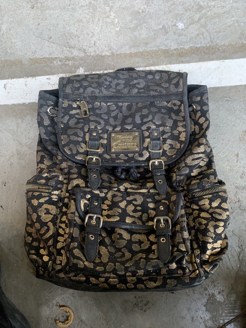 Juicy Couture Leopard Print Backpack (Category: Backpacks) located in Lucena. Submitted by nhelo_mill.6 (Listing ID 1422105195, Image 1). Description: - Stylish Juicy Couture backpack - Black and gold leopard print - Multiple compartments (side pockets, front flap) - Adjustable straps and top handle - Juicy Couture logo on front - Branded zippers.