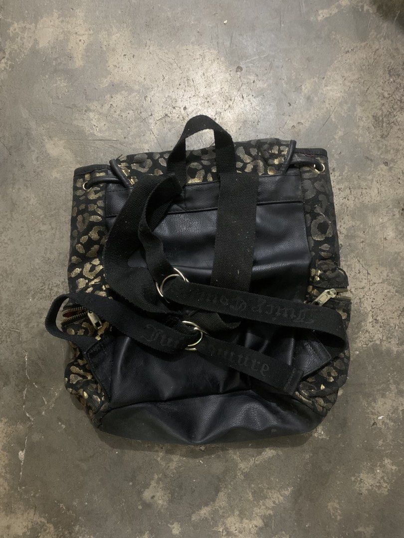 Juicy Couture Leopard Print Backpack (Category: Backpacks) located in Lucena. Submitted by nhelo_mill.6 (Listing ID 1422105195, Image 3). Description: - Stylish Juicy Couture backpack - Black and gold leopard print - Multiple compartments (side pockets, front flap) - Adjustable straps and top handle - Juicy Couture logo on front - Branded zippers.