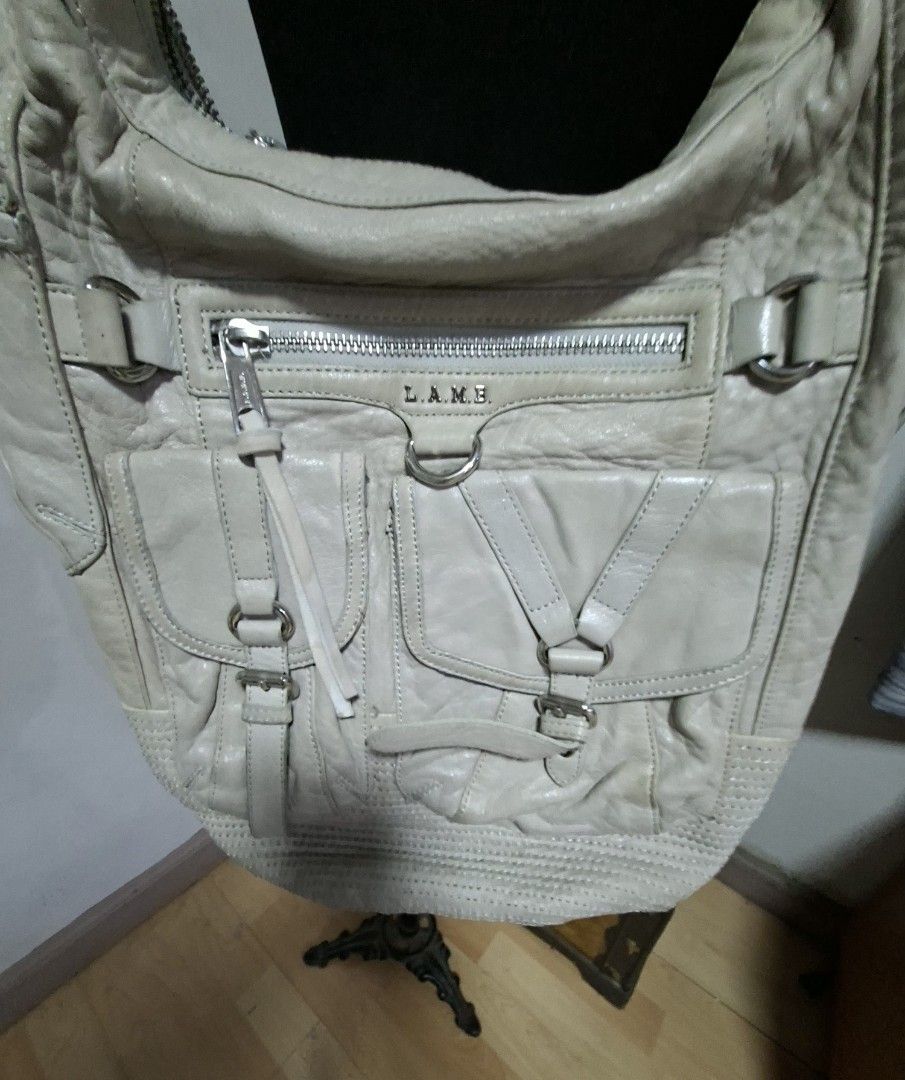 L.A.M.B. Shoulder Bag (Category: Luxury Bags & Wallets) located in Manila. Submitted by givesudlyt08 (Listing ID 1422168734, Image 2). Description: - L.A.M.B. shoulder bag - Neutral color - Multiple front pockets with buckle closures - Zippered top closure - Comfortable shoulder strap - Textured design on the bottom - Leather material.