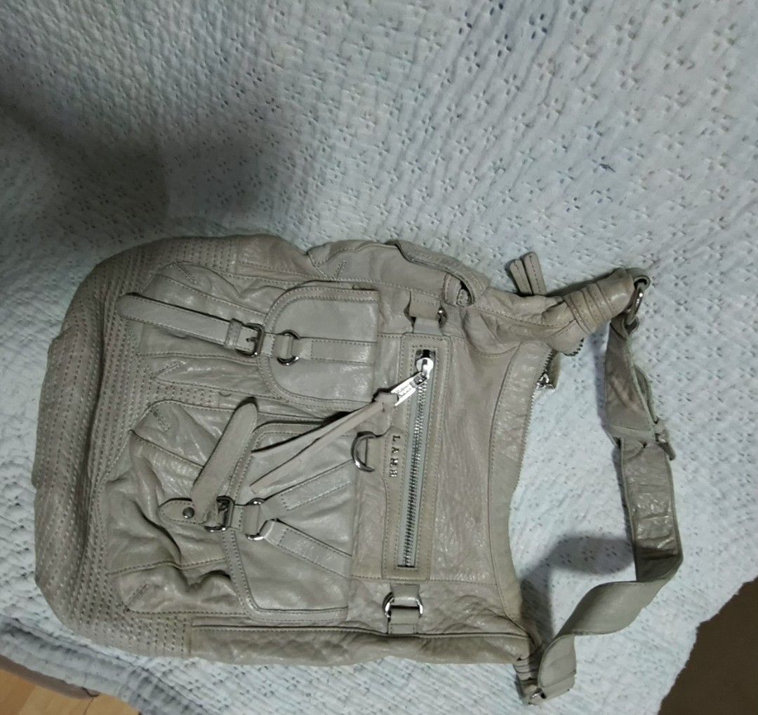 L.A.M.B. Shoulder Bag (Category: Luxury Bags & Wallets) located in Manila. Submitted by givesudlyt08 (Listing ID 1422168734, Image 3). Description: - L.A.M.B. shoulder bag - Neutral color - Multiple front pockets with buckle closures - Zippered top closure - Comfortable shoulder strap - Textured design on the bottom - Leather material.