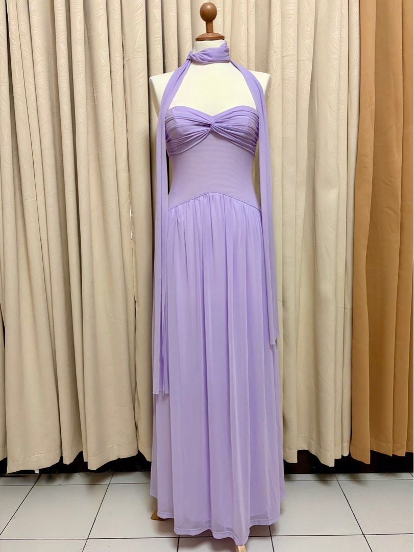 Lavender Halter Neck Maxi Dress (Category: Dresses) located in Pasig City. Submitted by KayeArtsy (Listing ID 1422131827, Image 1). Description: AU Bought 🇦🇺 AU14|XL - Lavender maxi dress - Halter neck design - Fitted bodice with gathered detail - Floor-length, flowing skirt - Includes matching scarf - Ideal for formal events and special occasions.
