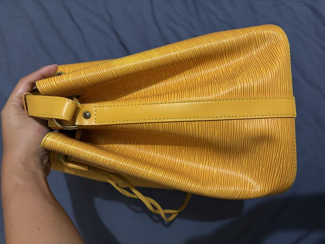 Louis Vuitton Epi Bucket Bag Yellow (Category: Luxury Bags & Wallets) located in Manila. Submitted by dmmai (Listing ID 1422189383, Image 2). Description: - Authentic Louis Vuitton Epi Bucket Bag - Vibrant yellow Epi leather - Drawstring closure - Adjustable shoulder strap - Purple fabric lining - malinis - Gold-tone hardware - Small LV logo detail - Buckle closure on strap - Provided drawstring slider (not real leather) - Personally bought in Ja