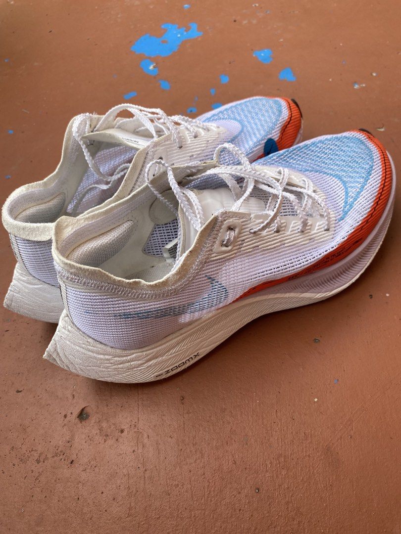 Nike Vaporfly Running Shoes (Category: Sneakers) located in Bacolod City. Submitted by 0411a (Listing ID 1422120962, Image 2). Description: Nike Vaporfly running shoes. Features a white and blue colorway with orange accents. The shoes have a ZoomX midsole and a Vaporfly logo on the tongue. The size is US 7.5, EUR 38.5, and CM 24.5 The shoes have some wear on the soles and insoles. AUTHENTIC!!! (no box).