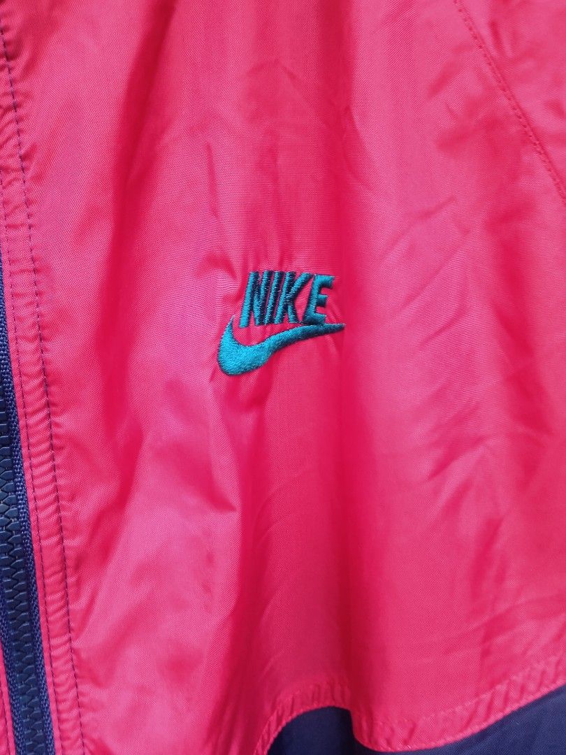 Nike Vintage Windbreaker Jacket XL (Category: Coats, Jackets and Outerwear) located in Cavite. Submitted by size_dimes (Listing ID 1422231726, Image 3). Description: - Vintage Nike windbreaker jacket - Size: XL - Color scheme: Navy, pink, and teal - Design: Color block - Features: Hood and zip closure - Logo: Embroidered Nike logo on the chest.